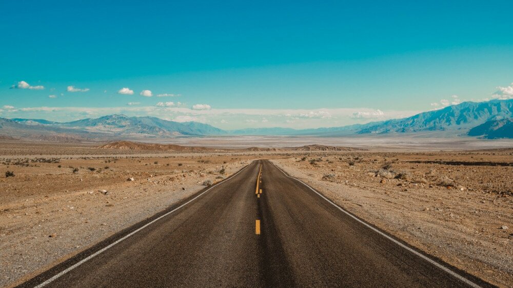 Eye-level shot of a road in the desert of Death Valley, California