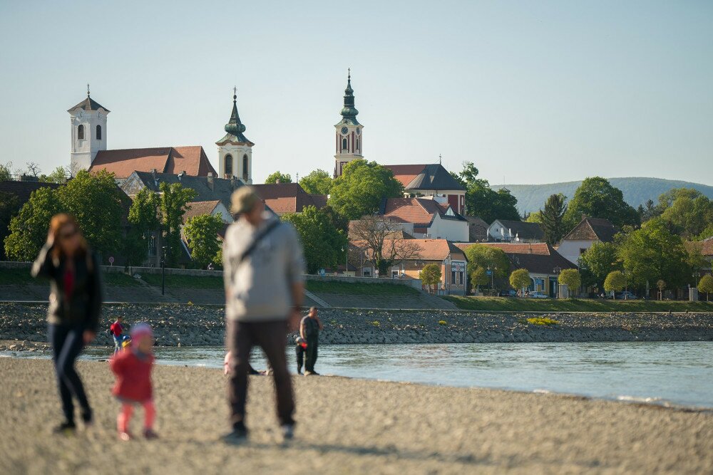 Unrecognizable family walk on the banks of the Danube in Szentendre, Hungary. In the background you can see the city.